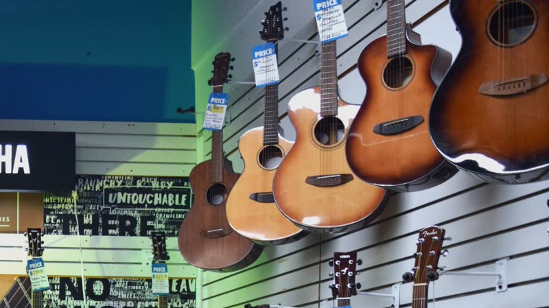 Acoustic guitars hanging on the slat wall