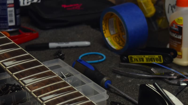 The repair bench with a guitar being serviced