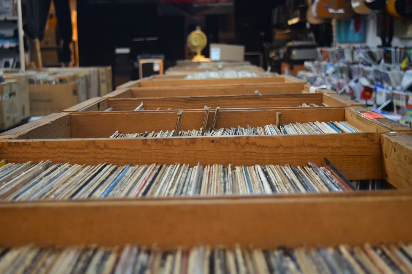 Rows of wooden crates packed with vinyl records at Musicians Discount Center in Cutler Bay