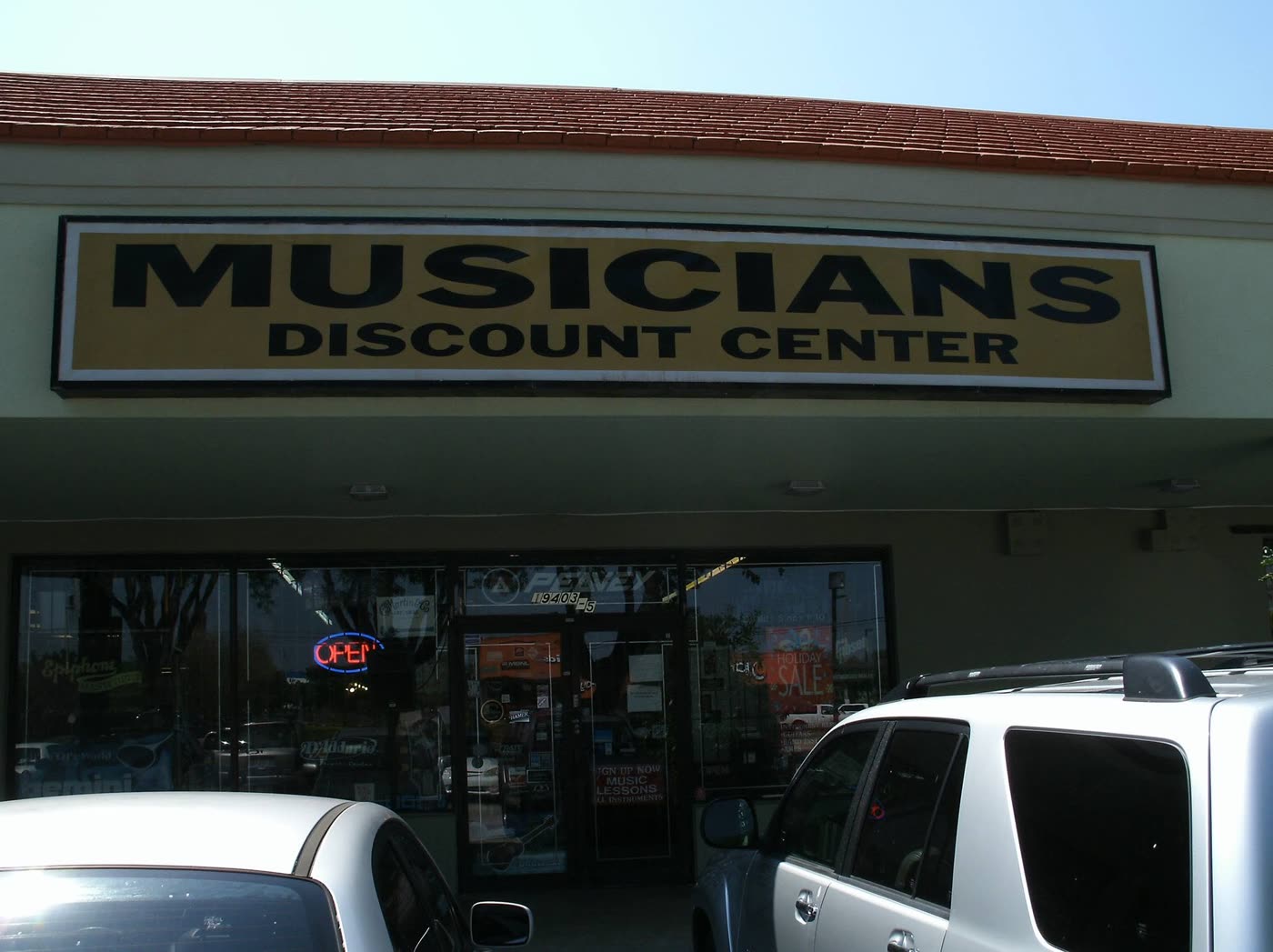 The Musicians Discount Center storefront on South Dixie Highway in Cutler Bay, with the store sign and a Music Lessons notice on the door